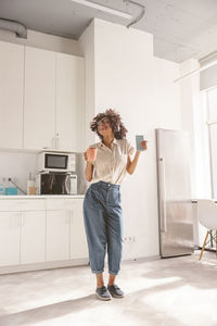 Side view of young woman standing in office