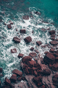 High angle view of rocks in sea