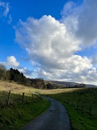 Empty road along countryside landscape