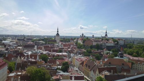 View of cityscape against cloudy sky
