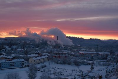 Aerial view of buildings against sky during winter