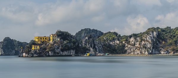 Panoramic view of sea and buildings against sky