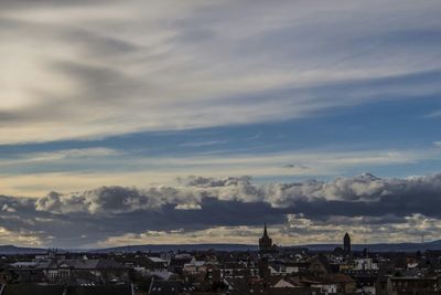 Cityscape against cloudy sky