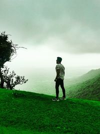 Rear view of man standing on golf course