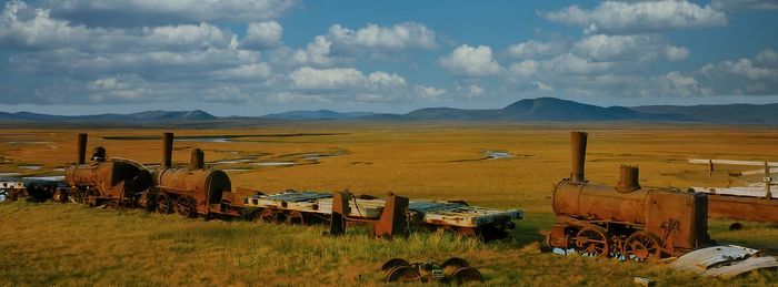 Panoramic view of agricultural field against sky