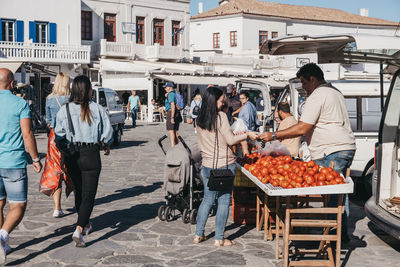 People at market stall in city