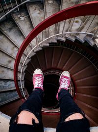 Low section of woman on spiral staircase