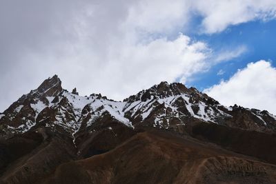 Scenic view of mountains against cloudy sky