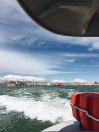 Boat moored on sea against sky