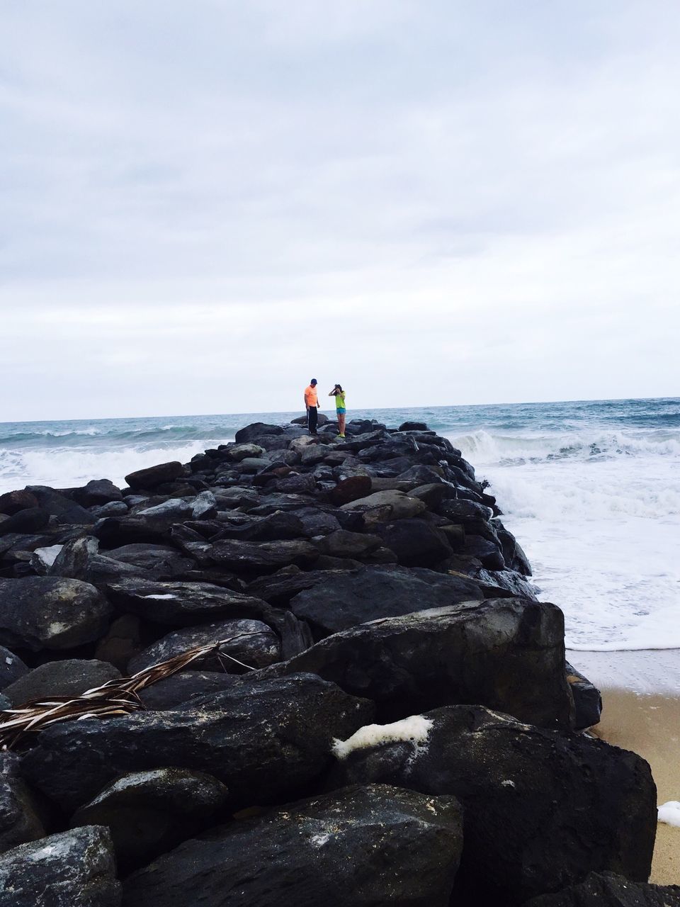 sea, horizon over water, water, sky, rock - object, lifestyles, leisure activity, scenics, men, tranquility, beauty in nature, tranquil scene, rear view, person, full length, nature, rock formation, beach