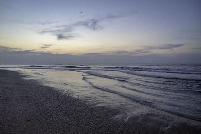 Scenic view of beach against sky during sunset