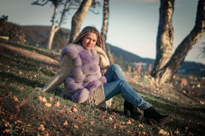 Portrait of smiling young woman in park during autumn