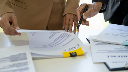 Midsection of man working on table