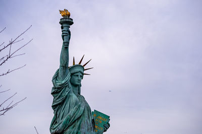 Low angle view of statue of liberty against sky