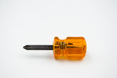 Close-up of yellow bottle against white background