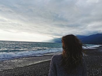Woman on beach against sky