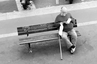 Full length of man sitting outdoors