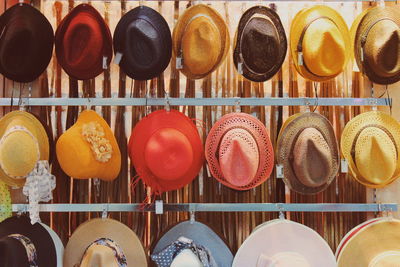 Close-up of colorful hats hanging for sale at market