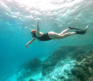 Full length of woman swimming undersea