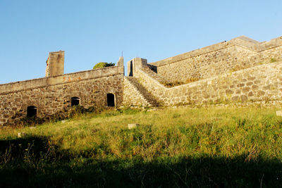 Low angle view of fort against clear sky