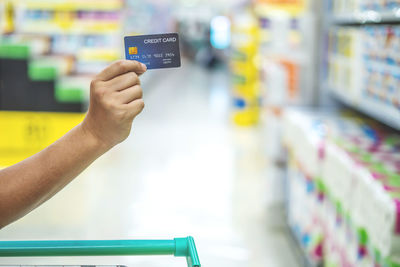 Close-up of human hand holding store