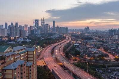 High angle view of illuminated cityscape during sunset