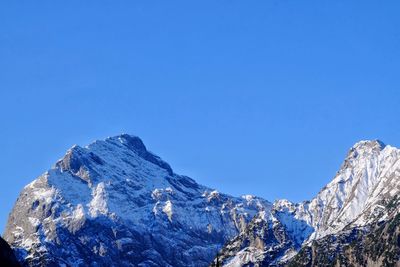 Scenic view of snowcapped mountains against clear sky