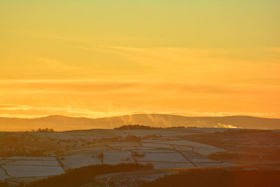 Scenic view of mountains against sky during sunset