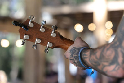 Close-up of man playing guitar