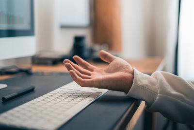 Cropped hands using laptop on table