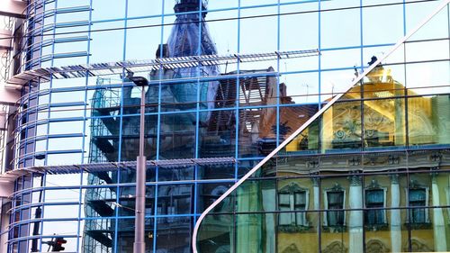 Low angle view of glass building against clear sky