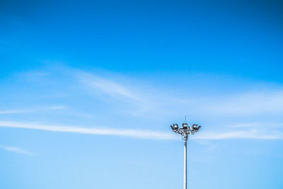 Low angle view of street light against blue sky