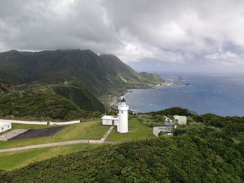 Scenic view of sea and mountains against sky