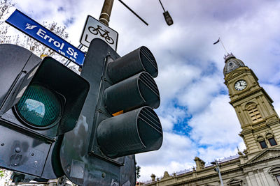 Low angle view of road signal against buildings