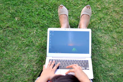 Low section of person on grassy field