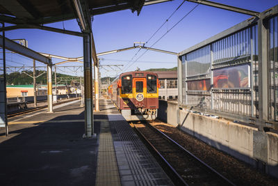 Train at railroad station against sky