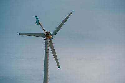 Low angle view of wind turbine against sky