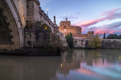 Arch bridge over river against sky