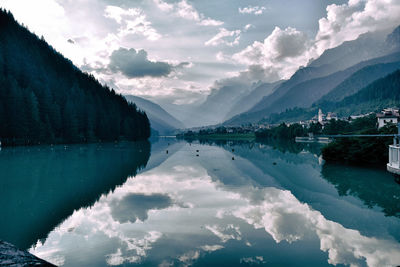 Scenic view of lake by mountains against sky