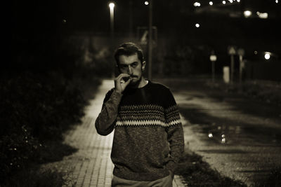 Young man using smart phone at night