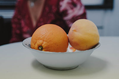 Close-up of orange and peach in bowl