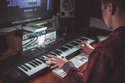 Low angle view of man playing piano