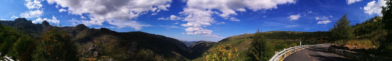 Panoramic shot of road against cloudy sky