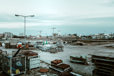 Man working at construction site in city against sky