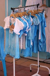 Clothes hanging on coathangers in clothing store