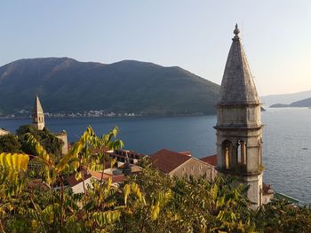 View of church at waterfront against sky