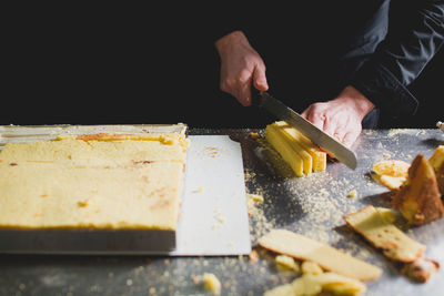 Close-up of chef cutting sponge cake