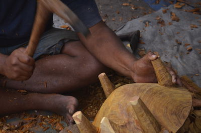 Low section of man working on wood