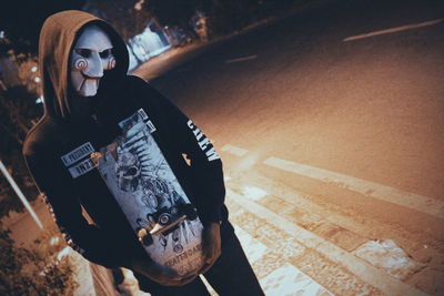 Portrait of smiling man standing on street at night