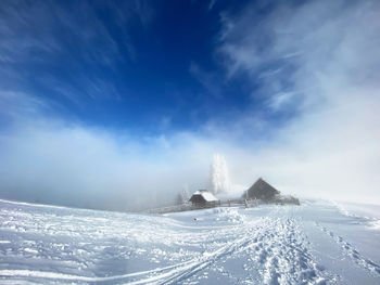 Scenic view of snow covered mountain against sky